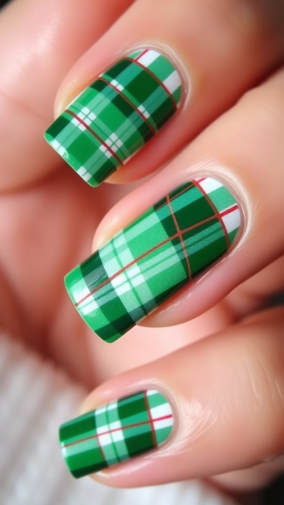 Close-up of green plaid Christmas nail art with red accents on a festive background.